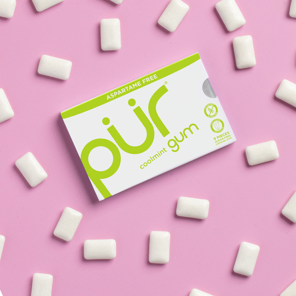 Box of PUR gum with white pieces on a pink background