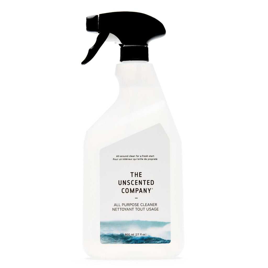 Clear spray bottle with black nozzle labeled 'The Unscented Company' on a white background