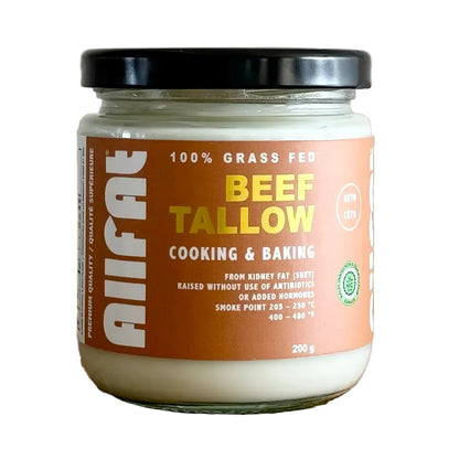 Jar of beef tallow on a wooden surface with a tiled wall background