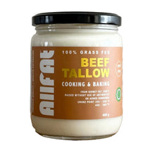 Jar of beef tallow on a wooden surface with a tiled wall background