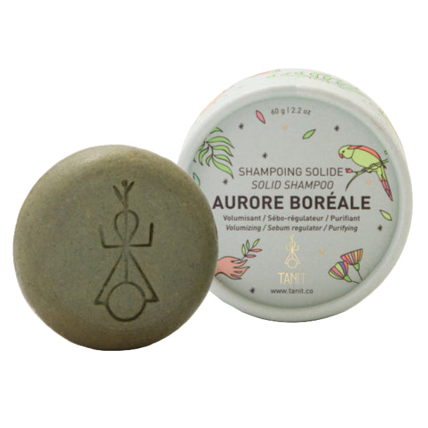 Solid shampoo bar and container labeled 'Aurore Boréale' on a white background