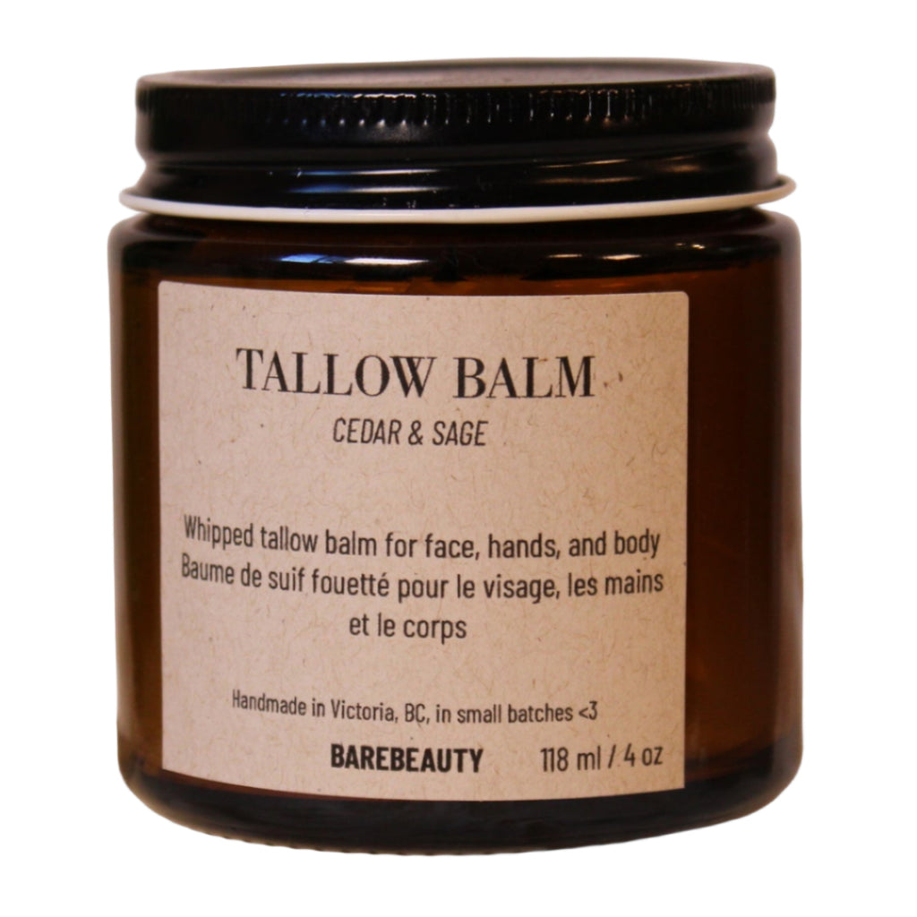 Tallow balm jar with label on a wooden block against a beige background