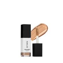 Emancipative cosmetic concealer bottle with applicator on a light gray background