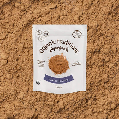 Package of Organic Traditions Cacao Powder on a brown background