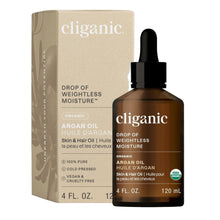 cliganic argan oil bottle and packaging on a beige background