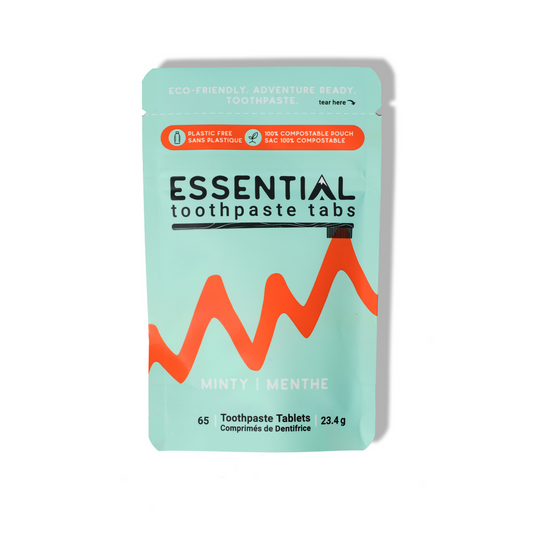 Packaging of Essential toothpaste tabs with a mint green background and red design.