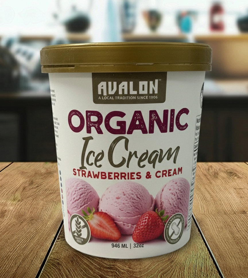 Avalon Organic Ice Cream container with strawberries and cream flavor on a wooden surface.