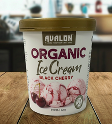 Avalon Organic Black Cherry ice cream container on a wooden surface