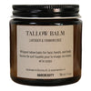 Bottle of Tallow Balm with lavender and frankincense scent on a wooden surface.