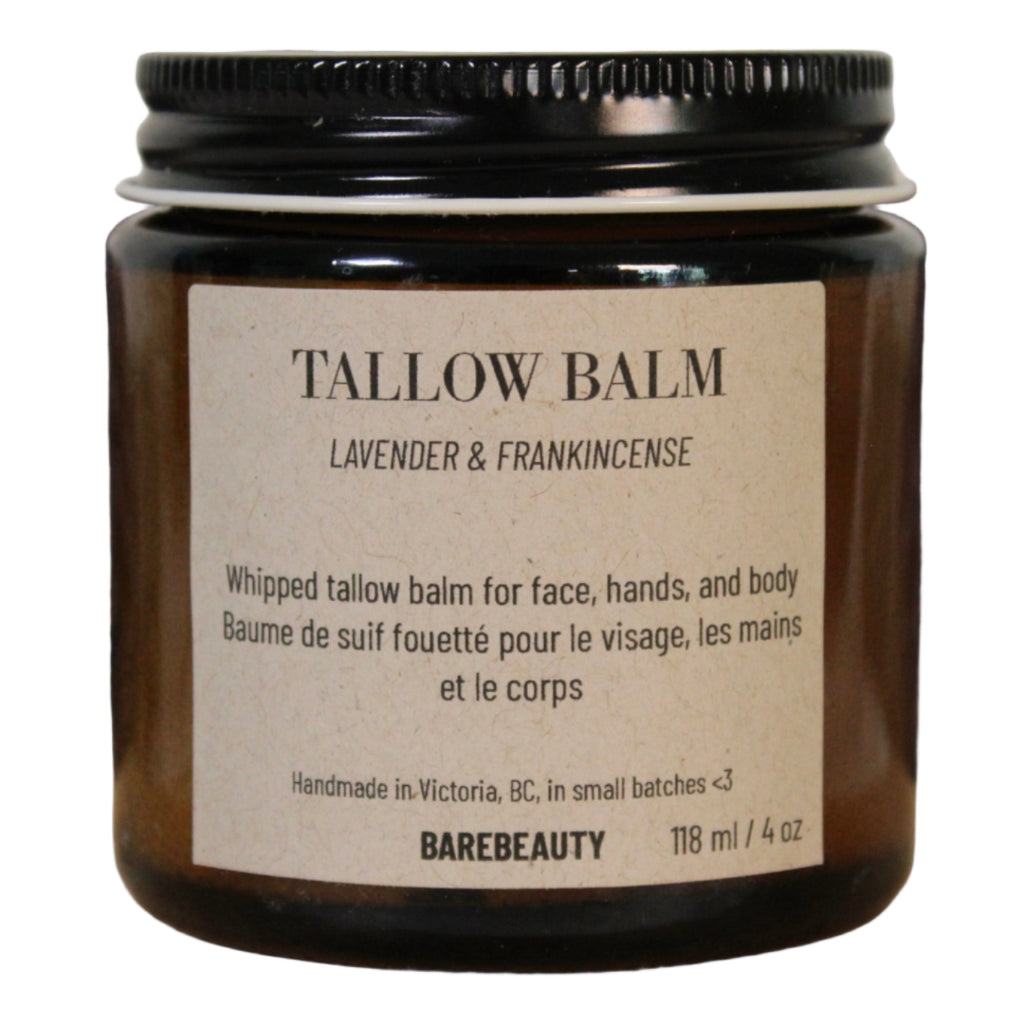 Bottle of Tallow Balm with lavender and frankincense scent on a wooden surface.