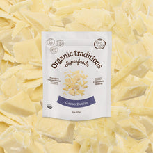 Package of Organic Traditions Cacao Butter on a bed of cacao butter flakes