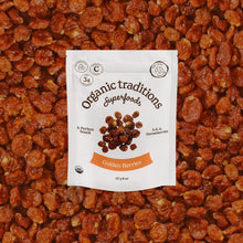 Packaging of Organic Traditions Superfoods Golden Berries on a bed of golden berries.