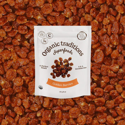 Packaging of Organic Traditions Superfoods Golden Berries on a bed of golden berries.