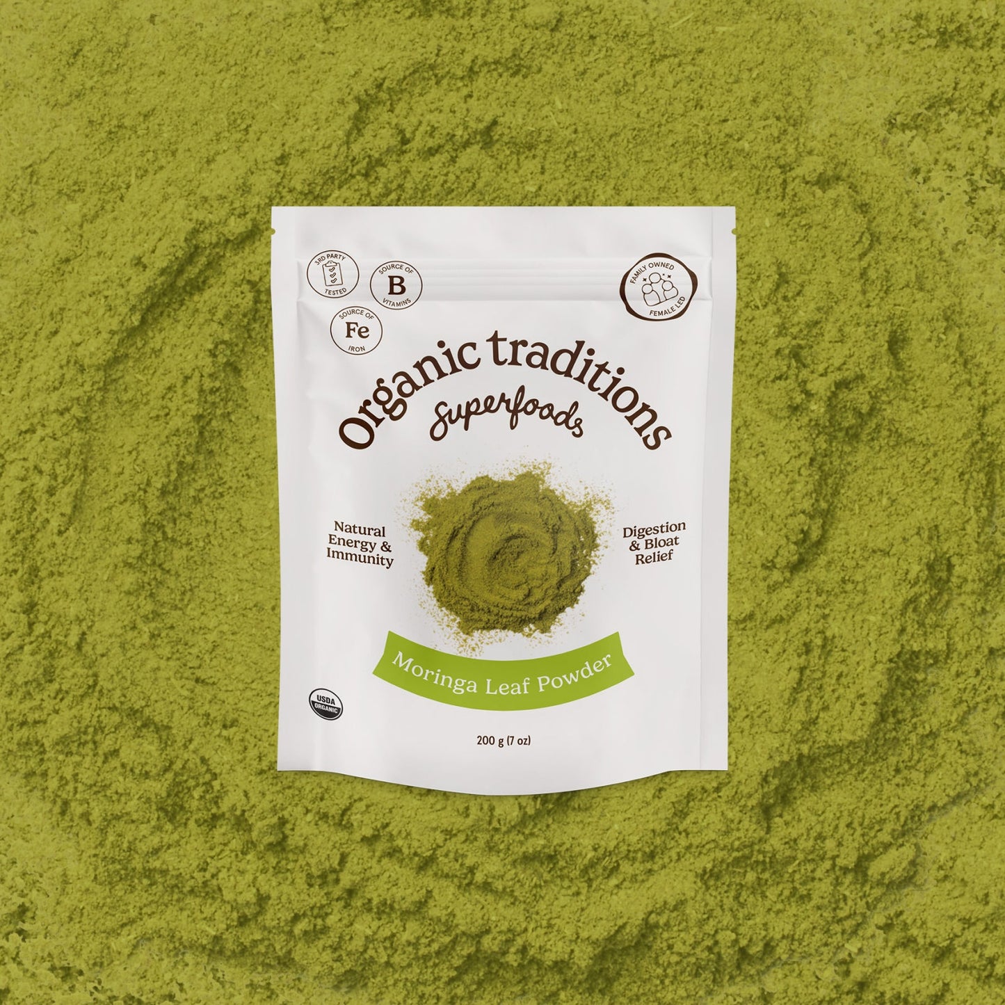 Package of Organic Traditions Moringa Leaf Powder on a green background