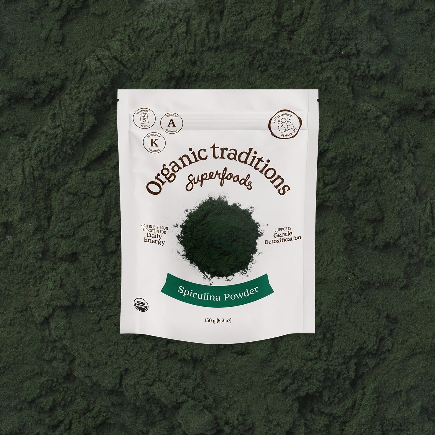 Package of Organic Traditions Spirulina Powder on a green textured background