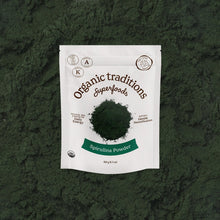 Package of Organic Traditions Spirulina Powder on a green textured background