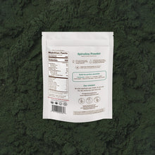 Spirulina powder package on a green textured background