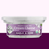 Container of garlic and herb cream cheese spread with a purple label on a white background