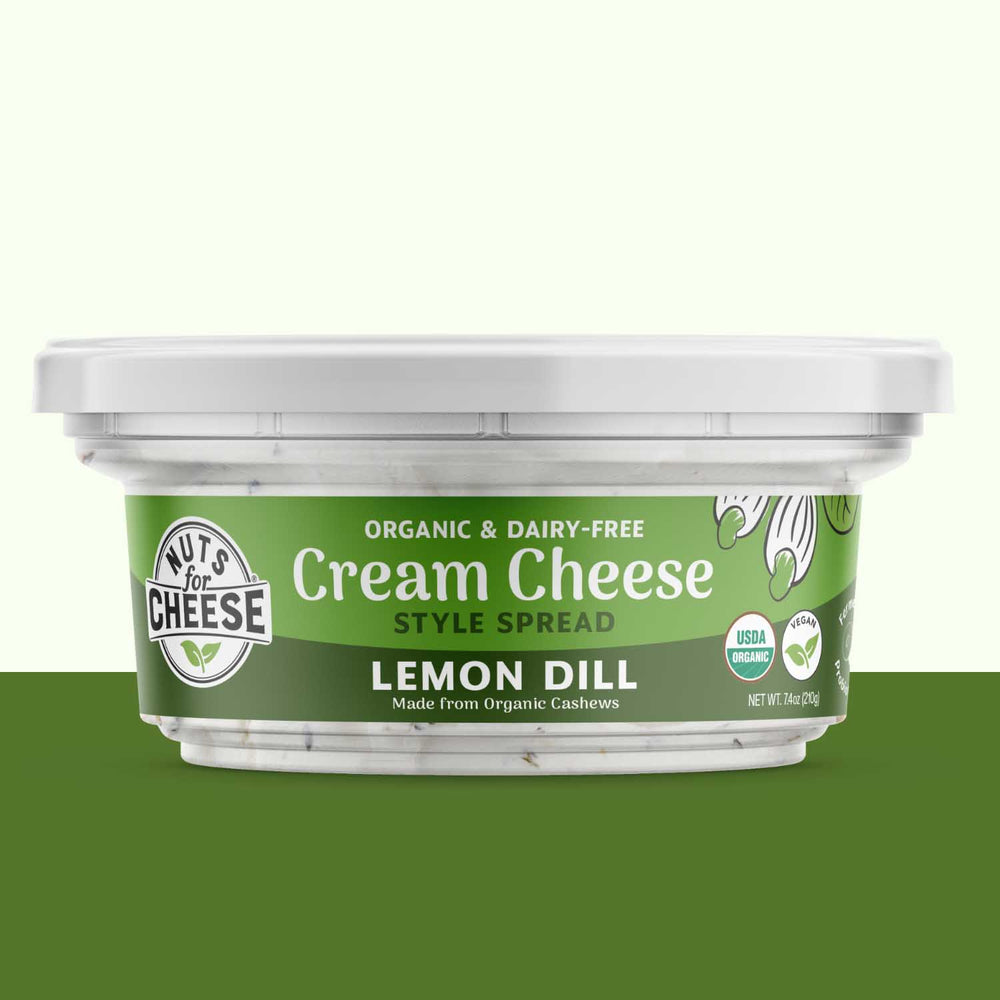 Container of Lemon Dill cream cheese spread with a green label on a white background