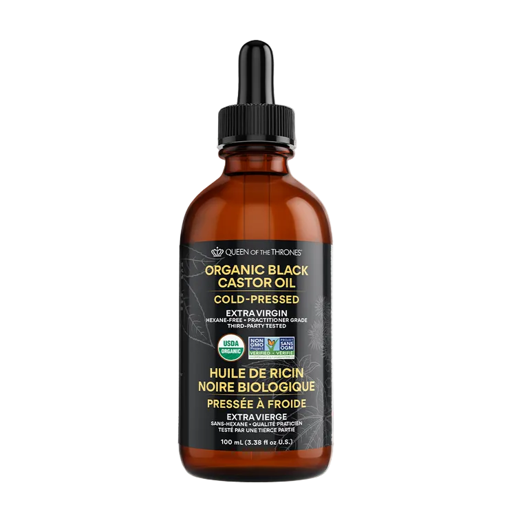 Bottle of organic black castor oil with a dropper on a gray background