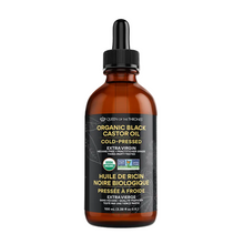 Bottle of organic black castor oil with a dropper on a gray background