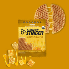 Honey Stinger energy waffle package with a waffle slice on a yellow background