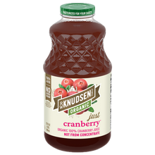 A bottle of Knudsen Organic Just Cranberry juice with a green cap and a cream-colored label featuring cranberry illustrations, isolated on a white background.
