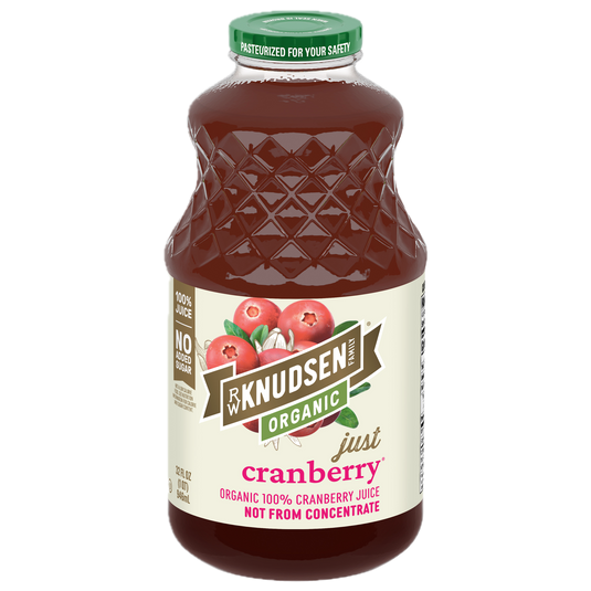 A bottle of Knudsen Organic Just Cranberry juice with a green cap and a cream-colored label featuring cranberry illustrations, isolated on a white background.