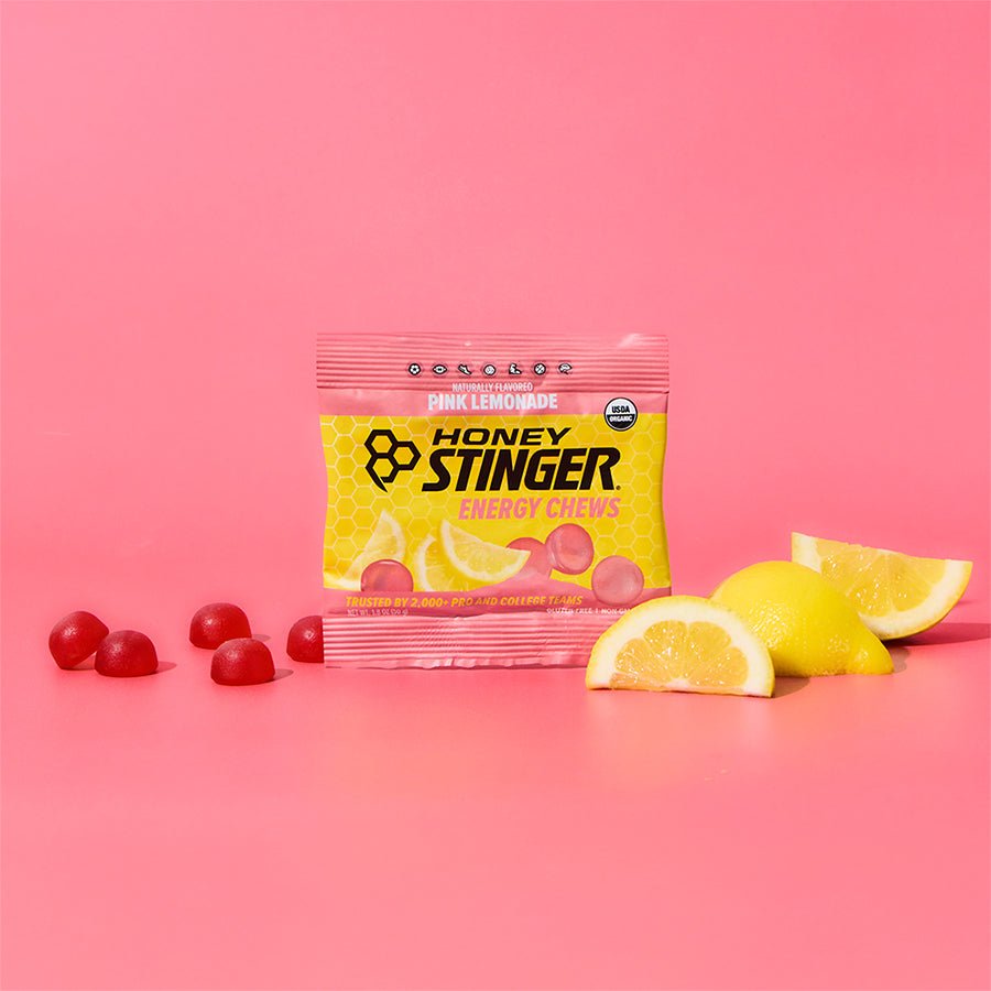 Honey Stinger energy chews package with pink lemonade flavor on a pink background