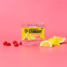 Honey Stinger energy chews package with pink lemonade flavor on a pink background